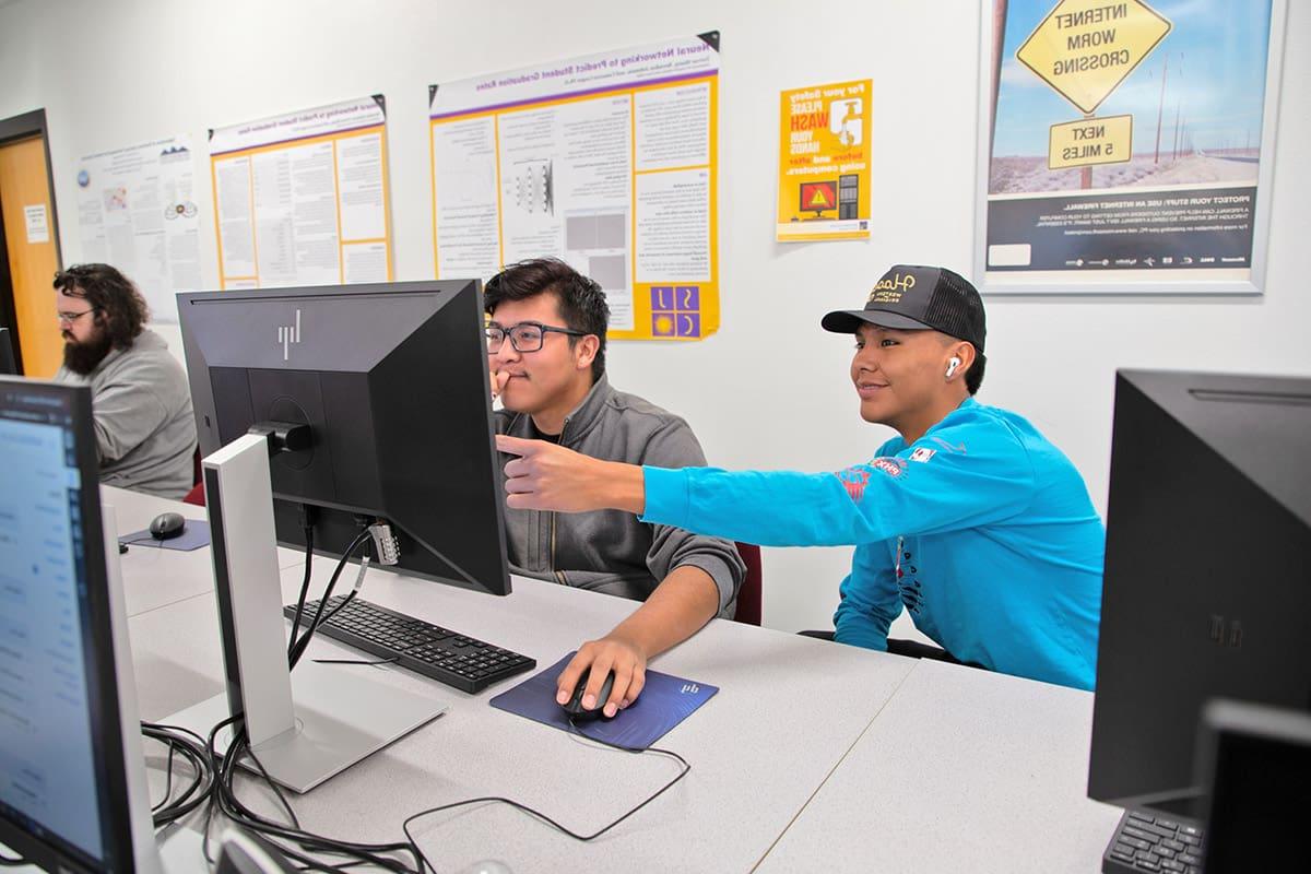 Students working on computers in IT class